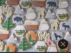 many decorated cookies are displayed on a white tablecloth with the words welcome to michigan