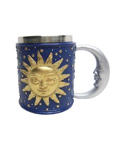 a blue and gold mug with a sun face on it