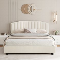 a white bed sitting in a bedroom on top of a hard wood floor