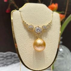 A stunning natural yellow pearl, carefully selected for its rich hue and radiant luster. Decorated this central gem is a halo of meticulously set zircon stones. It creates a luxurious and captivating effect, making this necklace a perfect statement piece for any high-end occasion like a gala, a sophisticated dinner, or an important celebration, this necklace promises to elevate your ensemble with its unmatched grandeur. Pearl Type: Freshwater Edison Pearls Pearl Quality: AAA [Shape]: Perfect Rou Elegant Yellow Halo Jewelry, Elegant Round Gemstone Bridal Necklace, Elegant Pearl Necklace With Diamond Gems, Elegant Yellow Diamond Necklace For Anniversary, Exquisite Round Pearl Necklaces, High Luster Diamond Necklace For Anniversary, Formal Bridal Necklace With Pearl Pendant, Elegant Yellow Bridal Necklace For Formal Occasions, Elegant Pearl Necklace With Gemstone In Round Pendant