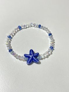 This will come with the pattern and color beads in the picture, and a blue starfish.                                                  * NOTE:*                         The bracelet in the picture is 6.5 inches.                         If you pick a different size the pattern           of beads in the back will be slightly different.  ANY QUESTIONS AT ALL OR CUSTOM ORDERS PLEASE DON'T HESITATE TO MESSAGE ME I WILL GET BACK TO YOU ASAP! -Please roll-on bracelets to avoid   over-stretching. -As with Cheap Ocean-inspired Beaded Bracelets For Gift, Cheap Ocean-inspired Beaded Bracelet, Cheap Blue Bracelets With Starfish Charm, Adjustable Blue Starfish Jewelry, Adjustable Blue Bracelets With Starfish Charm, Blue Bracelet With Starfish Charm And Round Beads, Blue Bracelets With Starfish Charm And Round Beads, Blue Star Jewelry For Vacation, Blue Star Shaped Jewelry For Vacation