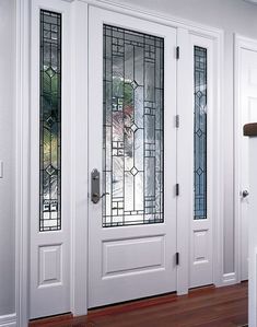 two white doors with stained glass and wood flooring