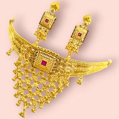 A stunning gold-plated Thewa necklace set featuring intricate floral and leaf motifs with red stone accents. The necklace has a traditional Rajasthani design with a choker-style base and a cascading drop pendant, and the earrings complement the necklace with delicate detailing. Material: Gold-plated with Thewa inlay work Design: Intricate floral and leaf motifs with red stone accents Set Includes: Necklace and matching earrings Occasion: Perfect for weddings, parties, and special occasions Style Kaan Chain, Choker Jewellery, Fancy Design, Real Gold Jewelry, Gold Necklace Set, Gold Work, Choker Style, Indian Traditional, Exclusive Jewelry