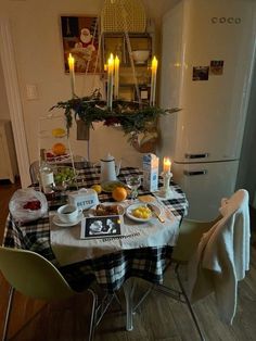 a dining room table is set with food and candles