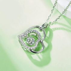 An eye-catching round moissanite dances with ease at the center of this appealing women's necklace, expressing your unstoppable love. Additional round gem set in sterling silver frame the center. Features Moissanite was originally found in meteorites(Chemical name: Silicon Carbide). It was first discovered in 1893, while a scientist was examining meteor samples from a crater in Arizona. After many years, the experts has been recreated moissanite in the laboratory, that make the gemstone with fri Pave Necklace, Double Heart Necklace, Women's Necklace, Silicon Carbide, Moissanite Necklace, Stone Material, Moissanite Jewelry, Round Moissanite, Double Heart