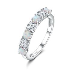 a white opal ring with five stones on the bottom and four diamonds in the middle