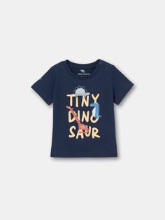 This tee is the ultimate combination of cool and cozy! With its eye-catching Tiny Dino print is sure to turn heads and make a statement. Made from high-quality materials, it's soft, warm, and perfect for any occasion. Playful Printed Short Sleeve T-shirt, Casual Letter Print T-shirt For Playtime, Unisex Short Sleeve T-shirt For Playtime, Screen Print Short Sleeve T-shirt For Playtime, Blue Fun T-shirt For Playtime, Playful Short Sleeve T-shirt With Text Print, Playful Short Sleeve Graphic T-shirt, Casual Graphic Print Tops For Playtime, Blue Graphic Tee With Letter Print