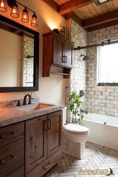 a bathroom with a toilet, sink and bathtub next to a window in it