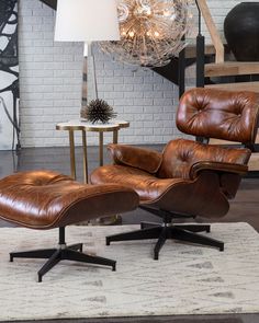 an image of a chair and ottoman in the living room with a chandelier