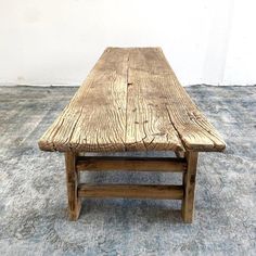 a wooden bench sitting on top of a carpeted floor