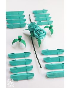 there are many pieces of paper that have been folded into flowers and leaves on them