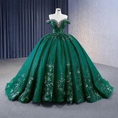 a green ball gown on display in a room