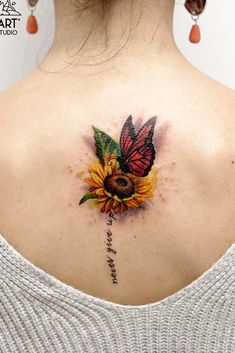 a woman with a sunflower and butterfly tattoo on her back