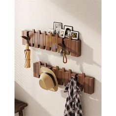 a hat and coat rack on a wall with hats hanging from it's hooks