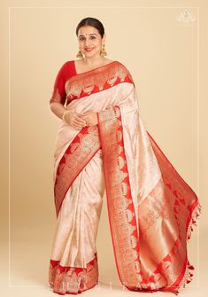 Exclusive Vidya Balan Special! The sight of this stunning Laal Paar Saree make us go, Jiya Dole Haule Haule! The fiery red seamlessly blends with a serene white in this luxurious drape. The decadent borders with charming dome-like motifs in Kadhiyal weaves heighten the elegance of the drape. The luxurious zari work that envelopes the body of the saree celebrates the inimitable craftsmanship of the Banarasi weavers. The  katan silk fabric promises  a lustrous texture and the zari in lays add a di Luxury Banarasi Silk Saree In Traditional Drape, Luxury Banarasi Silk Pre-draped Saree With Zari Work, Luxury Banarasi Silk Saree For Navratri, Luxury Banarasi Silk Saree For Celebration, Luxury Bollywood Banarasi Silk Pre-draped Saree, Luxury Banarasi Silk Pre-draped Saree For Puja, Luxury Banarasi Silk Pre-draped Saree For Diwali, Luxury Katan Silk Pre-draped Festive Saree, Luxury Katan Silk Pre-draped Saree For Festive Occasions