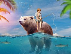 a boy is sitting on top of a bear in the water with fish around him