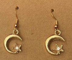 Super Crescent Moon and Star with embedded Rhinestone  Earrings with 925 Silver ear hooks (see photos) Charm is made from alloy  We have these designs for cat collars too, so you and your bestie can match! Earrings for you and a collar for your cat. See our other listings. Crescent-shaped Earrings With Star Charm As Gift, Crescent Earrings With Star Charm As Gift, Crescent Shaped Earrings With Star Charm For Gift, Crescent Earrings With Star Charm For Gift, Gold Moon-shaped Crystal Earrings Gift, Gold Moon Shaped Crystal Earrings For Gift, Gold Star Earrings With Moon Charm, Cool Piercings, Medieval Jewelry