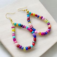 Teardrop is about 1.75 inches long Gold Plated Ear Hooks Glass Seed Beads Cheap Rainbow Jewelry With Dangling Beads, Beach Teardrop Beaded Earrings, Teardrop Beach Jewelry With Colorful Beads, Multicolor Beaded Earrings With Dangling Beads For Everyday, Multicolor Dangling Beads Earrings For Everyday, Multicolor Beaded Earrings For Everyday, Everyday Multicolor Beaded Earrings With Dangling Beads, Everyday Multicolor Beaded Dangling Earrings, Trendy Colorful Beaded Earrings For Everyday Wear