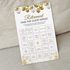 a sign that says retirement find the guest bingo on a couch with gold and white balloons