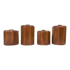 three wooden canisters sitting next to each other