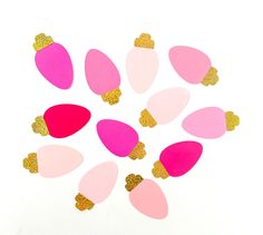 pink and gold heart shaped confetti cutouts on a white background with glitter hearts