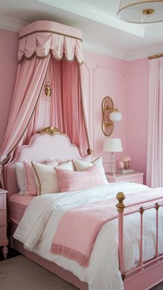 a pink and gold bedroom with canopy bed