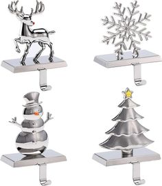 three metal christmas ornaments on stands with snowflakes and trees in the shape of reindeers