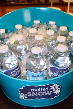 a blue bucket filled with water sitting on top of a counter