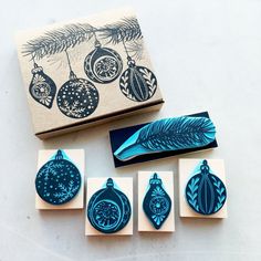 christmas ornaments stamp set in front of a box with rubber stamps on the bottom and an ornament next to it