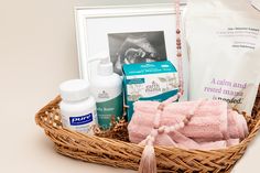 a basket filled with personal care items on top of a white table next to a framed photograph