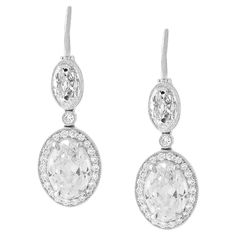 The stunning antique cut diamonds in these earrings are a testament to the craftsmanship and artistry of a bygone era, and highlight the unique beauty and character of antique diamonds. The two largest ovals weigh 1.01 carats each, and are certified by the GIA as a G IF and a G VVS2. The pair of oval tops weighs a total of 0.84 carats, and are approximately G color and VVS clarity. All four of the ovals have beautiful open culets and the distinctive charm of an old stone. The platinum mounting is modern, but its antique-inspired design accentuates the beauty of the diamonds and allows them to take center stage. The simple and elegant mounting is embellished with 0.23 carats of round diamonds, adding a touch of extra sparkle and sophistication to the design. Made in New York. Luxury Oval Bridal Earrings For Formal Occasions, Exquisite Oval Diamond Earrings With Accents, Exquisite Oval Diamond Earrings For Anniversary, Luxury Oval Diamond Earrings For Formal Events, Luxury Oval Diamond Earrings For Formal Occasions, Elegant Oval Diamond Earrings For Wedding, Exquisite Oval Brilliant Cut Diamond Earrings, Exquisite Oval Diamond Earrings With Brilliant Cut, Timeless Oval Brilliant Cut Earrings