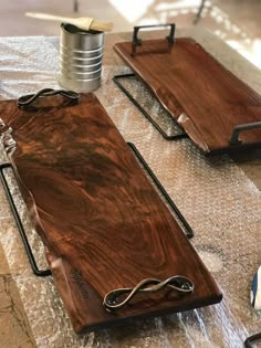 two wooden trays sitting on top of a table