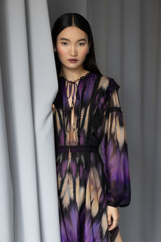 A line V-neck mini dress in abstract print silk viscose
with billowy sleeve, waist tie, and delicate lace trims. Luxe Fashion