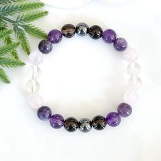 👉🏻All of my items are made with genuine, natural stones and crystals. Please be aware that no two stones are alike, that is what makes them unique. The size, colour and patterns of the beads will vary from piece to piece but these variations will not compromise the energy, beauty, and quality of your bracelet. This stunning gemstone bracelet features a harmonious blend of five different stones in shades of purple and pink, creating a vibrant and elegant accessory for women. The varied hues--fr Healing Crystal Bracelet With Mineral Stones, Mineral Crystal Bracelet With Stones As Gift, Mineral Crystal Bracelet With Stones For Healing, Healing Mineral Crystal Bracelet With Stones, Mineral Crystal Healing Bracelet With Stones, Mineral Crystal Bracelet For Healing, Spiritual Crystal Bracelet With Stones, Spiritual Mineral Crystal Bracelet With Stones, Spiritual Crystal Bracelet With Round Beads