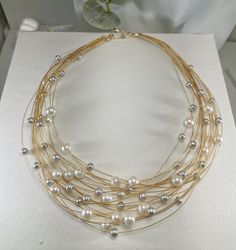 "This Modern & Classical multi-strands pearls necklace Titled \"21 strands of love\", measures from 17\"-19\"(multi-strands)long, it is made with two-tone pearls: AA grade white pearl 7-8 mm, and AAA Silver gray pearl 4mm. 14k gold color elegant cables. hand-made classic lobster claw clasp. it is the best gift for mom and wife for the anniversary event, wedding gift, Christmas gift,s, and Thanksgiving gift. This necklace is the Seattle Art Museum gift shop's selected piece" Luxury Yellow Gold Pearl Necklace For Celebration, Elegant Multi-strand Necklace For Anniversary, Gold Multi-strand Pearl Necklace, Luxury Multi-strand Pearl Necklace As Gift, Multi-strand Pearl Drop Necklace As Gift, Multi-strand Pearl Necklace For Gift, Luxury Double Strand Pearl Necklace For Gift, Multi-strand Pearl Necklaces For Gifts, Multi-strand Pearl Drop Necklace