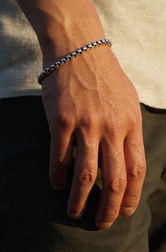 A refined essential for every man's jewelry collection. Crafted with precision, our 5mm Round Box Chain Bracelet transitions from day to night with ease. Wear it alone or anchor your stack with this staple piece. Sterling Silver 5mm Thickness Push Closure Determining your bracelet size: Encircle your wrist with a flexible tape measure and record the measurement. Because of the larger 5mm link size, add 3/4 to 1 inch to your wrist measurement for a comfortable bracelet fit. Choose the closest sta Classic Adjustable Cuban Link Bracelet For Everyday, Classic Cuban Link Bracelet With Box Chain, Minimalist Bracelets With Stainless Steel Clasp For Everyday Use, Minimalist Bracelets For Everyday Use, Everyday Silver Cuban Link Bracelet, Luxury Everyday Bracelets With Box Chain, Everyday White Gold Sterling Silver Bracelet With Solid Link, Minimalist Cuban Link Bracelet For Everyday, Minimalist Everyday Bracelet With Stainless Steel Clasp