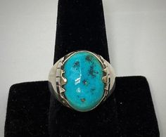 "Gorgeous Zuni handmade sterling silver and turquoise ring has a large round/oval shaped stone in the center from the Sleeping Beauty Mine, with sterling silver \"teeth\" designs surrounding the stone. Condition: Excellent! No damage at all and very minor wear consistent with age and handling Artist: Signed FG (Fred Guerrero) Stamped: Zuni Weight: 11 grams Size: 10 3/4 Measurements: Stone: 3/4 inches tall 1/2 inch wide" Artisan Turquoise Ring Round Collectible, Artisan Round Turquoise Ring Collectible, Untreated Round Turquoise Collectible Ring, Artisan Round Turquoise Collectible Ring, Artisan Oval Turquoise Collectible Ring, Oval Gemstone Western Rings, Western Style Oval Gemstone Rings, Western Style Untreated Oval Turquoise Ring, Artisan Oval Turquoise Ring