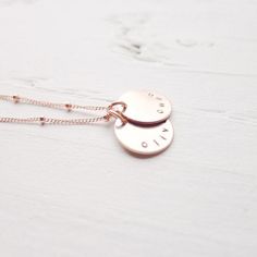 "I am in love with the color of rose gold! I'm excited to offer my best selling necklace in this warm, luxurious metal! The names of your choosing are hand stamped on rose gold filled medallions and lay on a delicate beaded rose gold filled chain. . { d e t a i l s } . Made to order. rose gold filled. . { m e a s u r e m e n t s } . 1/2\" disc 16 or 18\" in length . { o p t i o n s } . Please leave personalization preference in the notes to camileedesigns field at checkout This design in traditi Adjustable Engraved Rose Gold Necklace, Adjustable Rose Gold Everyday Necklace, Adjustable Rose Gold Necklace For Everyday Wear, Everyday Adjustable Rose Gold Necklace, Hypoallergenic Rose Gold Jewelry For Personalized Gifts, Hypoallergenic Rose Gold Charm Necklace With Round Pendant, Minimalist Rose Gold Hand Stamped Charm Necklaces, Rose Gold Round Disc Jewelry, Tarnish Resistant, Minimalist Rose Gold Hand Stamped Charm Necklace