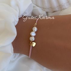 As a gift for your loved ones or for yourself, you will feel protected and safe <3 The bracelet is made of macrame yarn with freshwater pearls (5-6 mm). The spacer beads (3 mm) are made of stainless steel or, if gold-colored, 24k gold-plated. Optionally with a small stainless steel heart pendant. It is adjusted with a knotted sliding clasp so that it fits almost every wrist. Your piece of jewelry will be delivered ready for gifting with a beautiful card with meanings and motivational quote and in a delicate organza bag <3 Pearls: have a calming effect and are said to help balance karma. Yarn material: waxed polyester Pearl material: freshwater cultured pearls Material spacer beads: 24k gold plated or stainless steel Each gemstone/mineral/crystal/bead is unique and has its own shape and col Handmade Spiritual Pearl Bracelet, Gold Spiritual Pearl Bracelet For Gift, Elegant Handmade Gold-plated Pearl Bracelet, Handmade Adjustable Gold-plated Pearl Bracelet, Adjustable Multicolor Hand-strung Pearl Bracelet, Karma Bracelet, Freshwater Cultured Pearls, Tumbled Stones, Rock Crystal