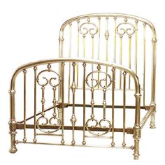 a white metal bed frame with ornate designs