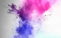 colorful powder is flying in the air on a white background with blue and pink colors