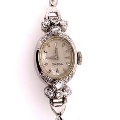 "Rare Ladies Collectable OMEGA 14k White Gold with approximately 1.25 carat of Natural Diamond Manual Wind Cocktail Watch.    It is set with 34 natural colorless diamonds weighing approximately 1.25 carats, the watch itself weighs 14.34 grams and is approximately 5.75\" inches in length.  Condition is Pre-owned. No original box, No original papers." Vintage Watch Claw, Classic Platinum Diamond Watch With Brilliant Cut, Classic Diamond White Watch With Brilliant Cut, Formal Diamond Jewelry With Vvs Clarity, Classic Diamond White Round Diamond Watch, Classic Diamond Jewelry With Brilliant Cut, Classic White Gold Jewelry With Brilliant Cut, White Diamond Round Watches, Classic Round Diamond Watch With Polished Finish