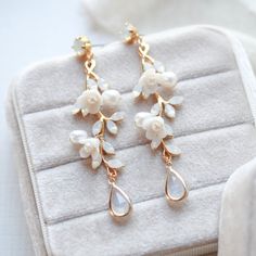 Our Lolita Gold Floral Freshwater Pearl Earrings will make your wedding day even more special. Carefully crafted with freshwater pearls and white opal Austrian crystals in an intricate floral design, these earrings will make you feel like an elegant and beautiful bride. Their timeless sophistication is the perfect finishing touch for your bridal look. - Handcrafted with genuine Austrian crystals - Created in my studio in PA- White opal crystals- Freshwater pearls- Polymer clay flowers- Yellow go Rose Gold Pearl Drop Flower Earrings, Rose Gold Flower Drop Earrings With Pearl, Rose Gold Flower-shaped Earrings With Pearl Drop, Rose Gold Flower Earrings With Pearl Drop, Pearl Drop Flower-shaped Bridal Earrings, Anniversary Rose Gold Pearl Earrings, Delicate White Pearl Earrings With Elegant Design, Flower-shaped Pearl Drop Earrings For Wedding, Flower Shaped Pearl Drop Earrings For Wedding