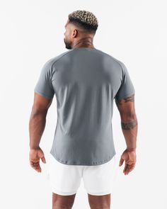 HIGHLIGHTS Fitted short sleeve Sweat-wicking, breathable fabric Rubberized aplique on chest Soft stretch fabric Straight hemline style FIT SUGGESTION. This item runs true to Alphalete’s standard. fit.. If you are between sizes, we recommend sizing up. Model is 6’0”/183cm, wearing a size XL with a 47”/120cm chest.. MATERIALS AND WASHING DIRECTIONS 96% Cotton and 4% Spandex. We recommend washing inside-out on a cold setting. Hang to dry Our Core Tee Shirt returns with an updated look and feel. Our Workout Shorts, Breathable Fabric, Stretch Fabric, Tee Shirt, Ash, Tee Shirts, How To Wear, T Shirt, Design