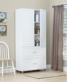 a white armoire sitting next to a window