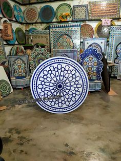 a large blue and white plate sitting on top of a table next to other plates