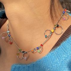 Add a splash of color to your ensemble with our Indie Kid Beaded Chain Choker. This playful accessory features a whimsical arrangement of multicolored beads interspersed along a delicate metal chain. Each bead is thoughtfully placed, creating a vibrant spectrum that complements any outfit Length: 42cm/ 16.5 in Aesthetic Choker, Whimsical Arrangement, Accessories Y2k, 90's Aesthetic, Aesthetic Accessories, Aesthetic Jewelry, Indie Kids, Elegant Accessories, Simple Necklace