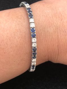 Set your eyes on this gorgeous and elegant vintage platinum cornflower blue sapphire and diamond tennis bracelet. The cornflower blue sapphires weigh approximately 5 carats. The diamonds weigh approximately 3 carats. The diamonds are VS-SI clarity and G-H color. This piece, circa 1950s, weighs 12.11 grams and is 7 inches long. Platinum Jewelry With Blue Single Cut Diamonds, Blue Single Cut Diamond Jewelry In Platinum, Blue Platinum Jewelry With Single Cut Diamonds, Blue Diamond Wedding Bracelet, Classic Sapphire Tennis Bracelet With Prong Setting, Classic Sapphire Diamond Tennis Bracelet, Silver Sapphire Tennis Bracelet With Brilliant Cut, Classic Sapphire Tennis Bracelet For Anniversary, Classic Blue Wedding Bracelets