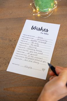 a person is writing on a wish list