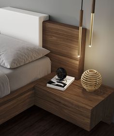 a bed room with a neatly made bed and a night stand on the side table